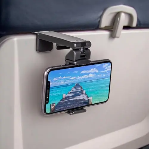 Black Perilogics universal phone mount clamped to an airplane tray table, holding a smartphone