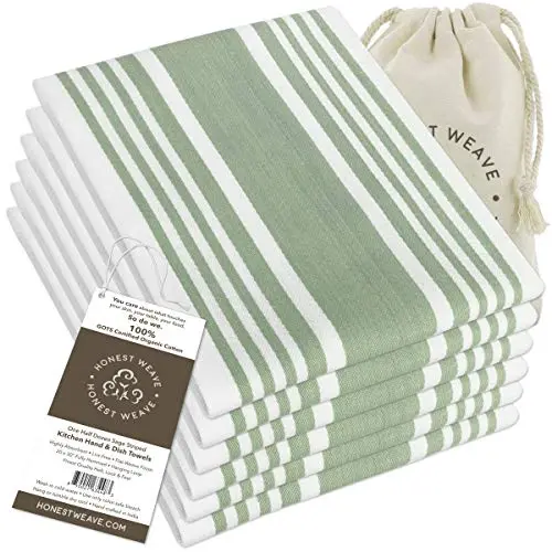 Honest Weave sage green striped organic cotton kitchen towels hanging on an oven door