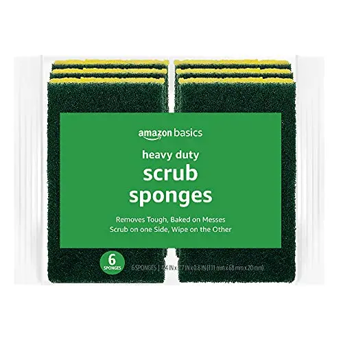 Pack of six Amazon Basics yellow and green scrub sponges next to a dirty pan