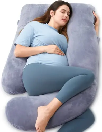 Momcozy grey U-shaped full body pregnancy pillow on a bed.