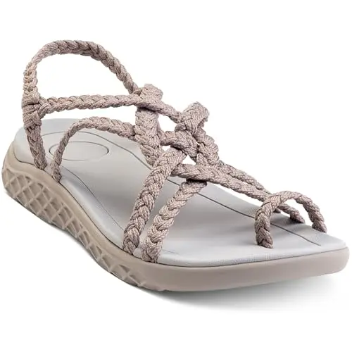 Plaka braided rope walking sandals on feet near water