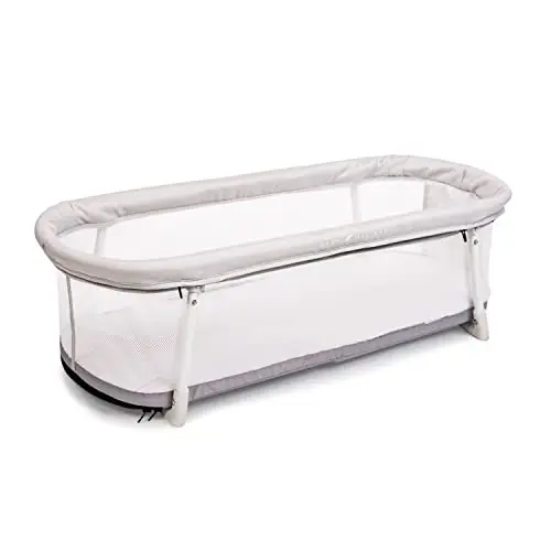 Baby Delight Snuggle Nest Bassinet packed inside a suitcase