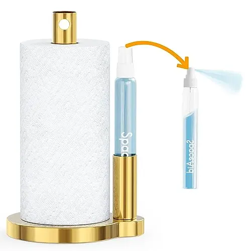 SpaceAid SprayNeat paper towel holder in gold with a side bar design, showing the spray bottle placed for easy access under a cabinet.
