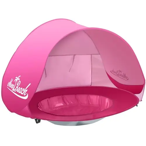 Pink Monobeach baby tent with a small pool bottom, set up on the beach.