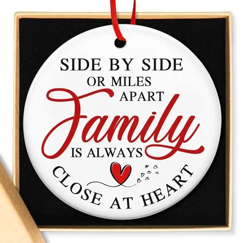 A round, glossy ceramic Christmas ornament with a colorful heart design and a sweet family-themed message printed on it.