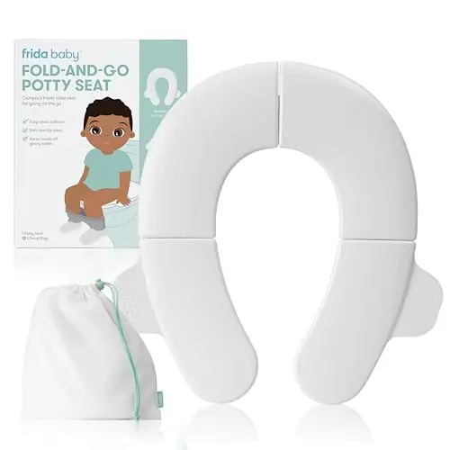 Frida Baby Fold-and-Go Portable Potty Seat in white, shown folded up with its included travel bag.