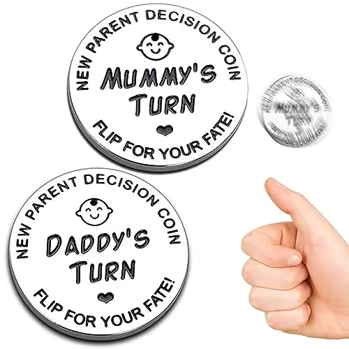 Close-up of a double-sided stainless steel coin engraved with Daddy's Turn on one side and Mummy's Turn on the other
