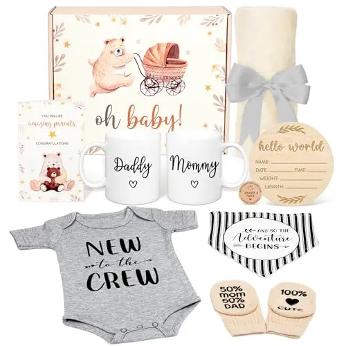New Parents Gift Basket containing ceramic Mommy and Daddy mugs, a large plush baby blanket, onesie, bib, socks, hello world sign, and decision coin.