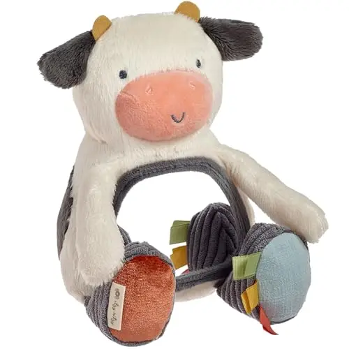 Itzy Ritzy cow-shaped plush sensory toy with a baby-safe mirror, crinkle paper, and ribbon tags