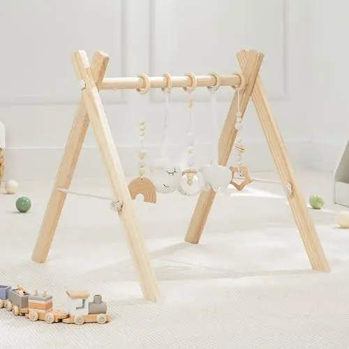 Natural wooden baby play gym with white and wood-toned hanging sensory toys