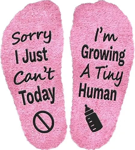 Pair of white socks with the funny text 'Sorry I Can't Today I'm Growing A Tiny Human' printed on them.