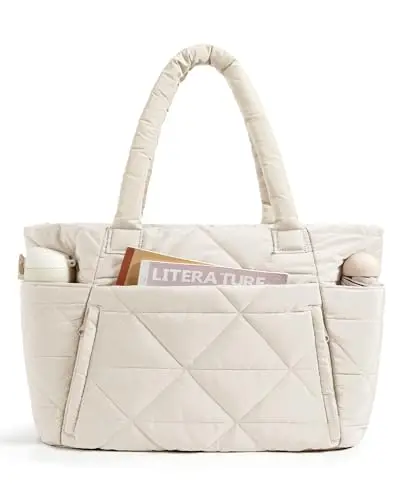 Beige puffy quilted tote bag for women with front zipper pockets, shown as a shoulder bag.