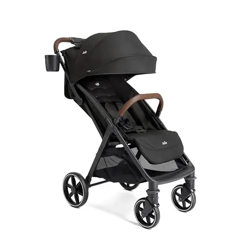 Joie Nutmeg compact stroller with UPF canopy folded next to a car