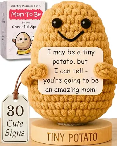 Small handmade crochet potato doll on a wooden stand with interchangeable paper affirmation signs