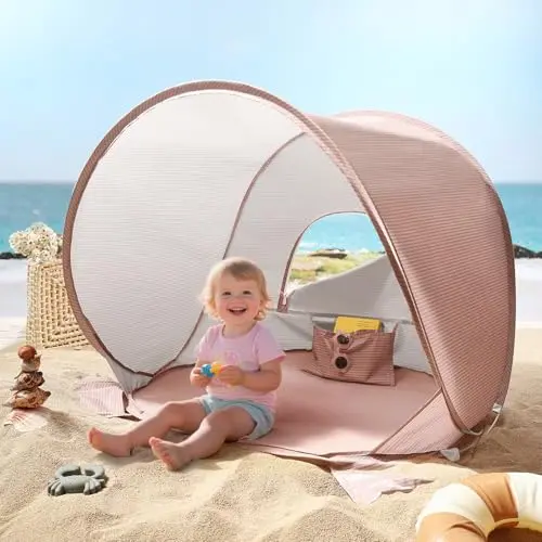 Tiny Land pink baby beach tent secured with sand pockets on a beach