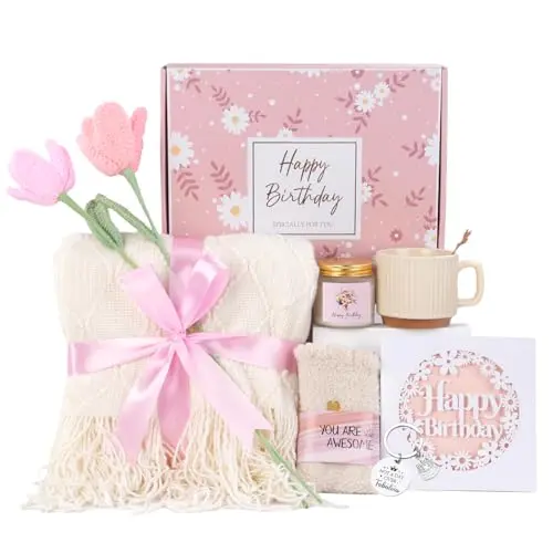 Gift box opened to reveal a knitted blanket, ceramic mug, candle, and socks