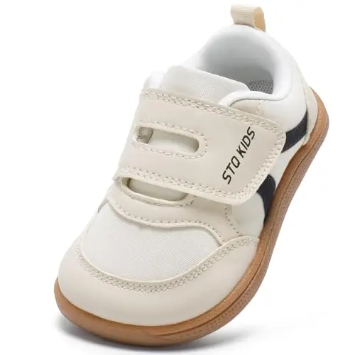 Beige and white toddler sneakers with wide toe box on grass