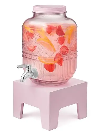 Godinger pink beverage dispenser with wooden base stand on a kitchen counter