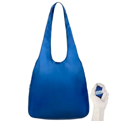 Nanobag Micro Tote in Navy, folded small next to a hand for scale